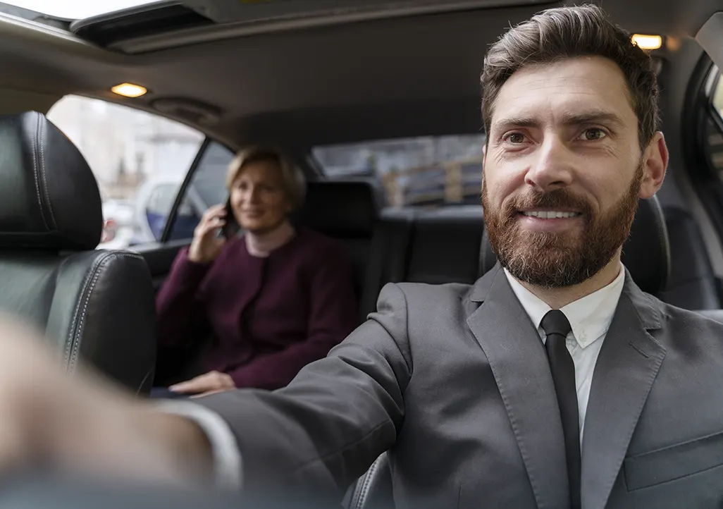 A map graphic with location pins in Dubai. The text features 'Luxury, Convenience, Reliability,' along with a luxury Audi A6 with a chauffeur. There are buttons for 'Call Us Now' and 'WhatsApp,' with the number +97145733533 for chauffeur-driven car rental needs in Dubai.